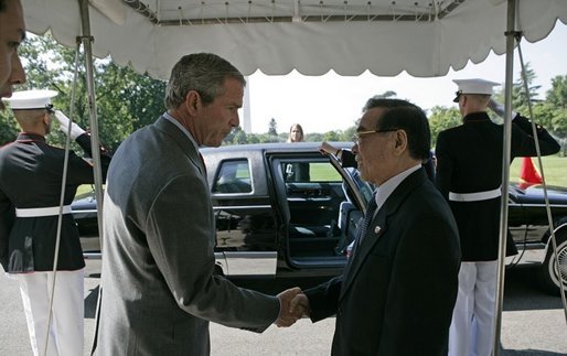 President George W. Bush shakes hands with Prime Minister Phan Van Khai of Vietnam as he departs the White House Tuesday, June 21, 2005. During the two leaders' meeting, President Bush expressed strong support for Vietnam�s accession to the World Trade Organization and accepted the Prime Minister's invitation to attend the 2006 APEC Summit in Vietnam. White House photo by Eric Draper